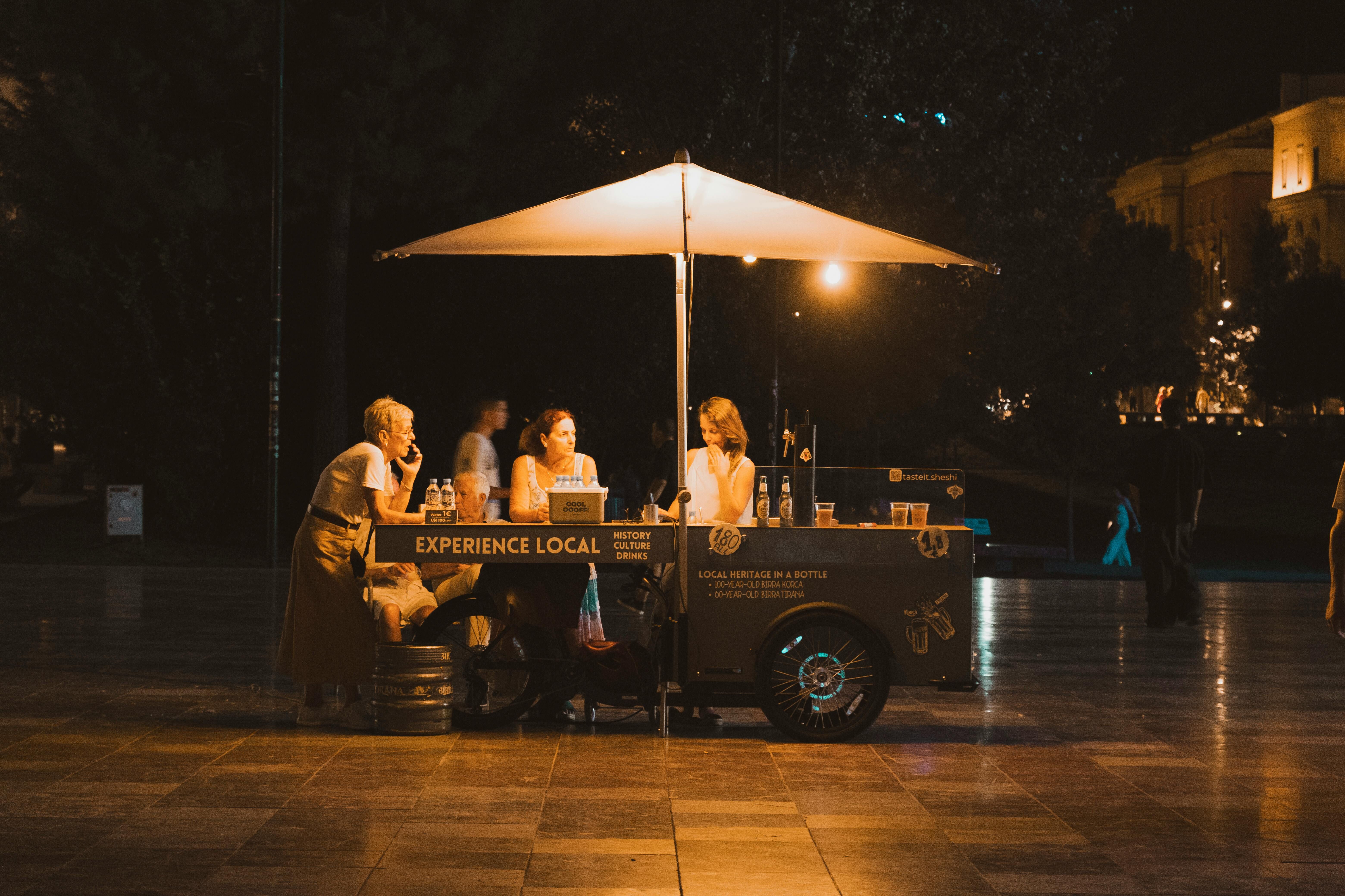 Evening Street Scene with Food Cart in Tirana · Free Stock Photo
